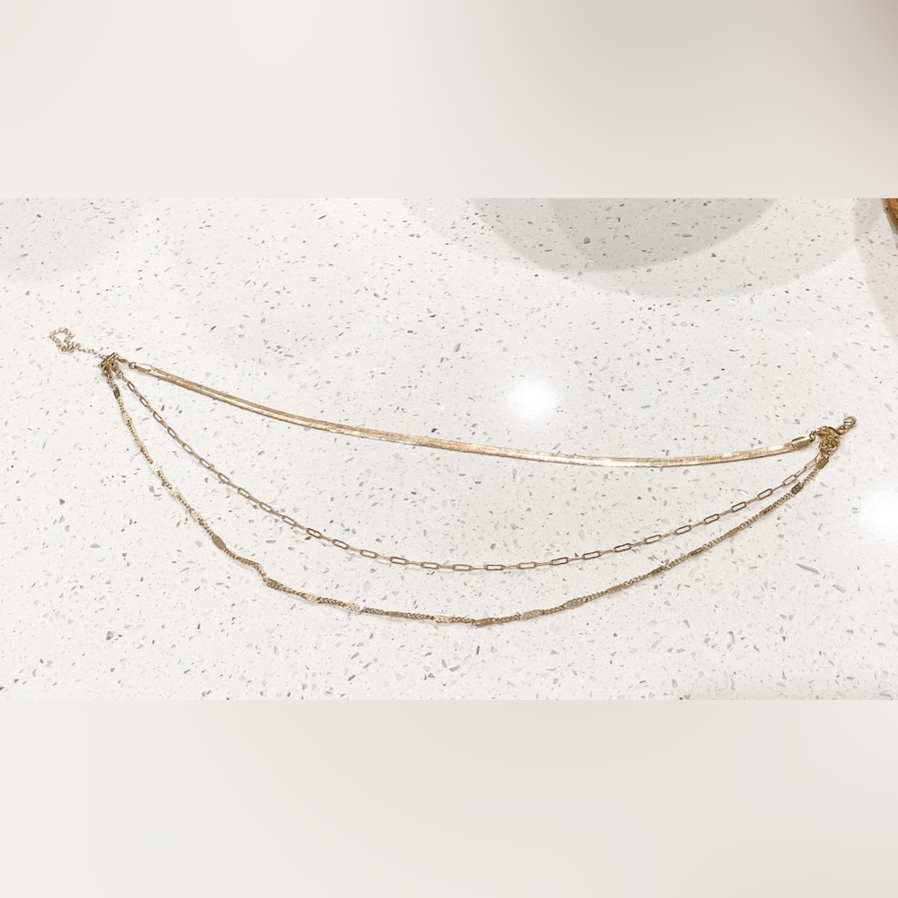 Gold colored three stacked necklaces
